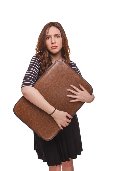 Woman holding a suitcase in hands isolated white background — Stock Photo, Image