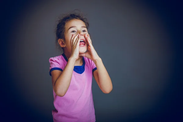 Baby girl calls for help from the person hands on a gray backgro — Stock Photo, Image