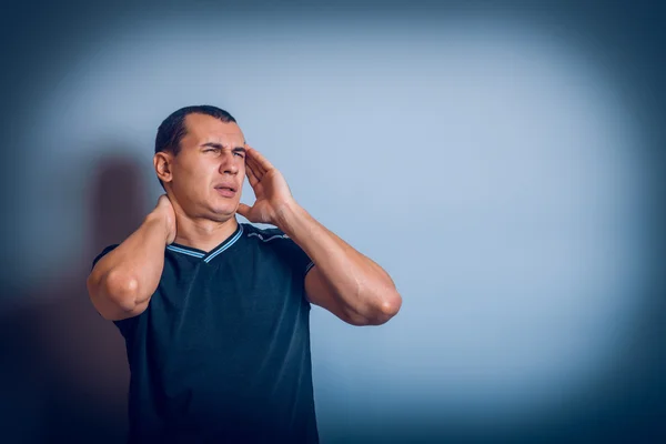 Male of European appearance brunet put his hands on head — Stock Photo, Image