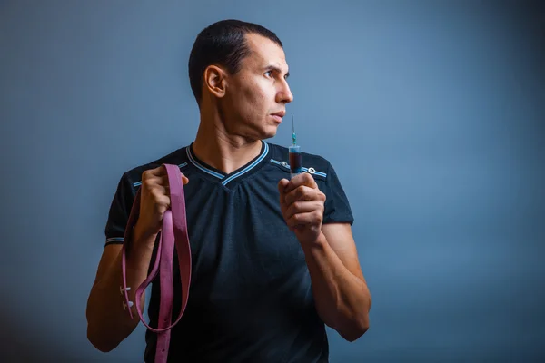 Ritratto di un uomo L'aspetto europeo tiene laccio emostatico — Foto Stock