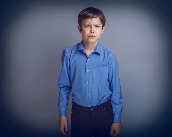 Teenager boy of 10 years European appearance portrait on gray — Stock Photo, Image