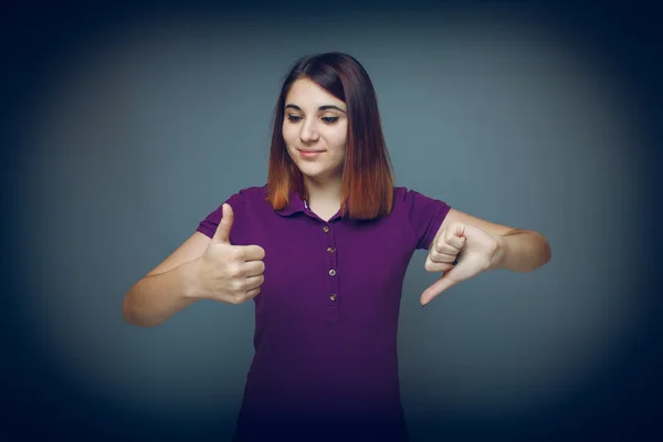 Girl 20 years of European appearance haired showing thumbs up si — Stock Photo, Image