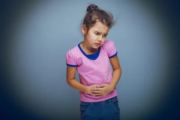 Girl child abdominal pain on gray background cross process — Stock Photo, Image