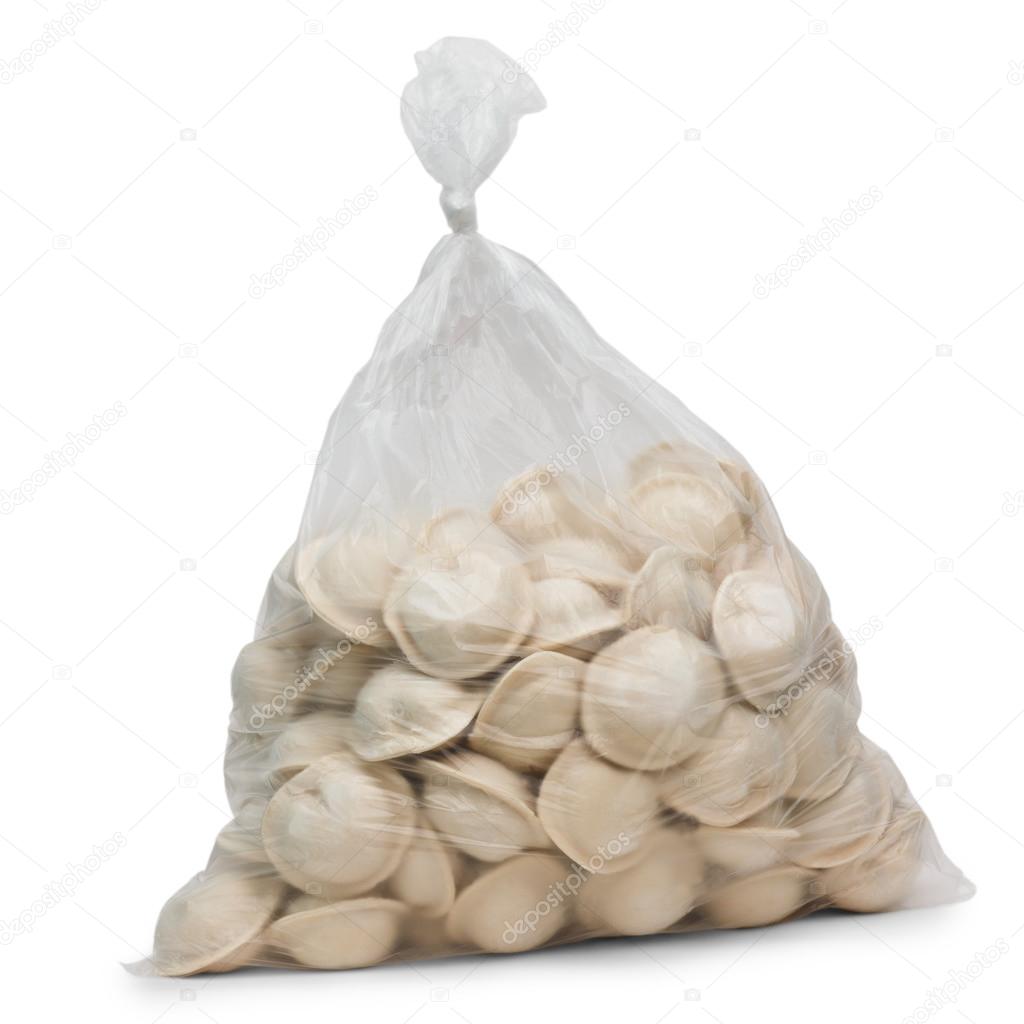 raw dumplings in plastic cellophane bag isolated on white backgr