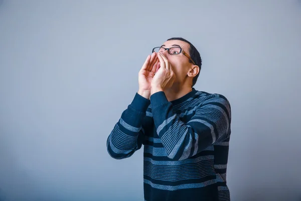 Male of European appearance brunet screams put hands to his — Stock Photo, Image