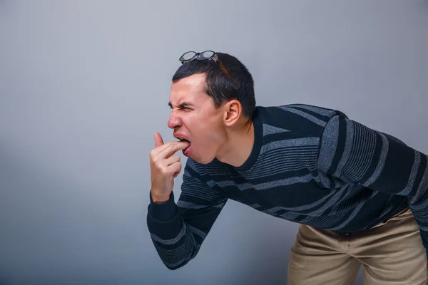 Male of European appearance brunette put his fingers in mout — Stock Photo, Image