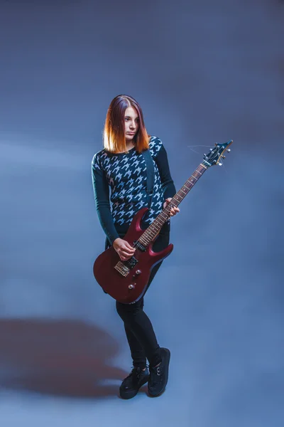 Ευρωπαϊκής εμφάνιση καφέ μαλλιά κορίτσι παίζει κιθάρα σε ένα γκρι bac — Φωτογραφία Αρχείου