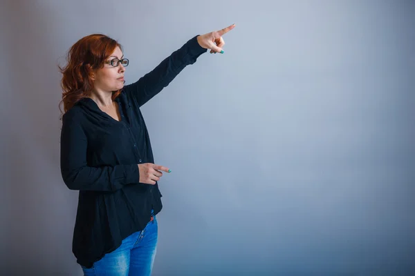European -looking  woman  of  30  years is pointing in the  dire — Stock Photo, Image