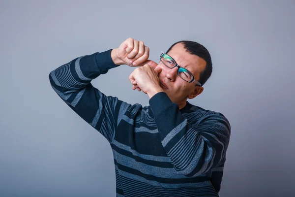 European-looking the man in a sweater brunet squeezing a pimple — Stock Photo, Image