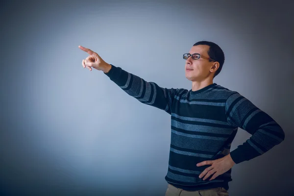 European-looking man with glasses shows his hand forward on a gr — Stock Photo, Image