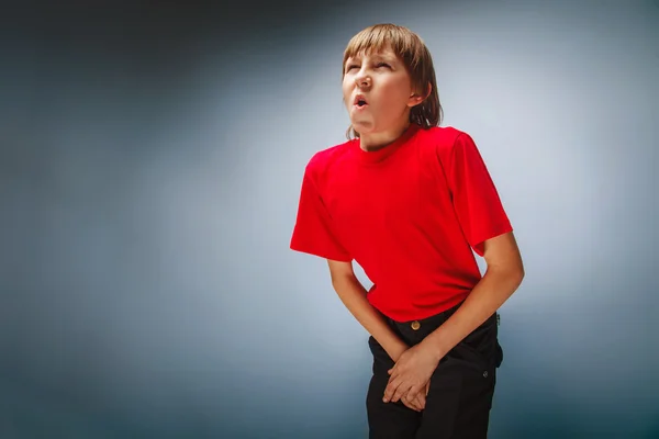 Boy teenager European appearance in a red shirt holding hands in — Stock Photo, Image