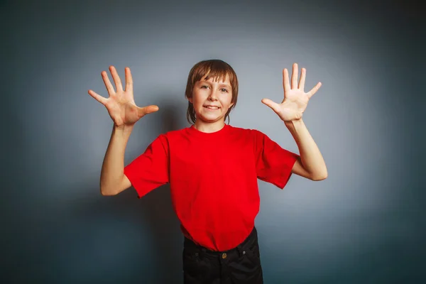 European-looking boy of ten years shows a figure ten fingers on — Stock Photo, Image