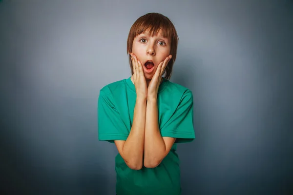 European-looking boy of ten years surprise, opened his mouth on — Stock Photo, Image