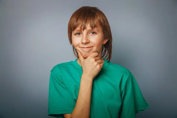 European-looking boy of ten years thinking, hand under his chin — Stock Photo, Image