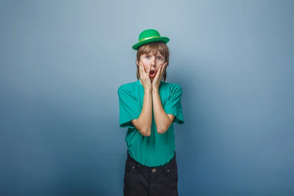 Aspecto europeo adolescente chico en camiseta con sombrero verde poner h — Foto de Stock