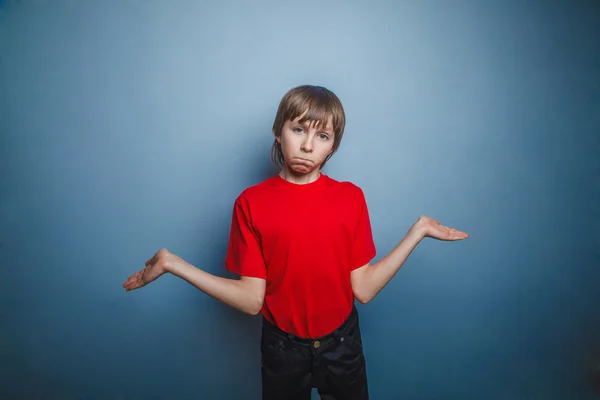 Boy, teenager, twelve years in the red shirt spread his hands, t — Stock Photo, Image