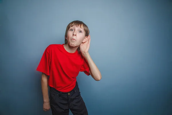 Niño, adolescente, doce años, con una camisa roja, sosteniendo una mano — Foto de Stock