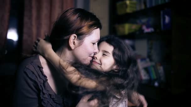 Moeder vrouw met glazen tiener dochter ervaring tederheid liefde kussen in de kamer in de avond — Stockvideo