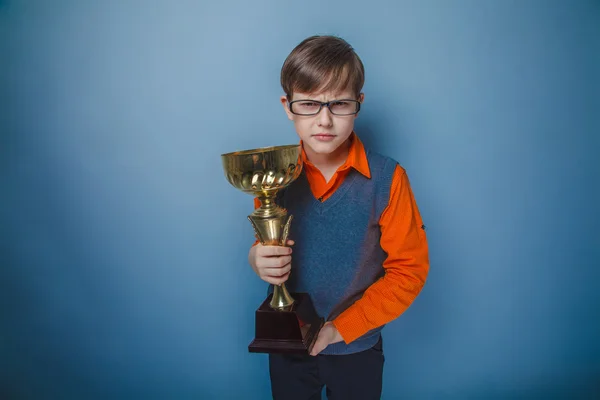European-looking boy of ten years in glasses award, smile, cup o — Stock Photo, Image