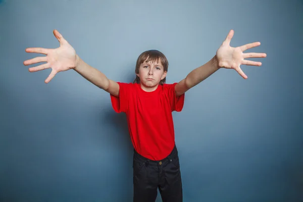 Boy, teenager, twelve years old,  a in red shirt, stretched his — Stock Photo, Image