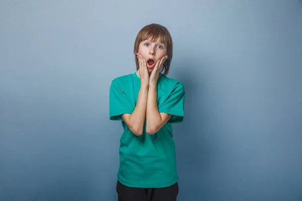 Chico, adolescente, doce años un en camisa verde, abrió la boca — Foto de Stock