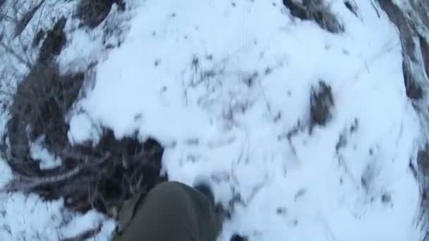 Man lopen op sneeuw en droog gras reis benen in laarzen close-up video gopro — Stockvideo