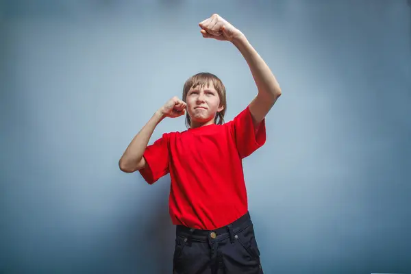 Boy, teenager, twelve years in  red shirt, showing his fists — Stock Photo, Image