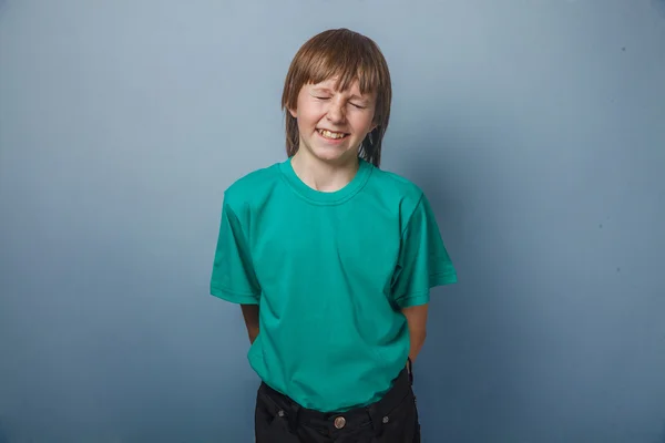 Boy, teenager, twelve years in a green shirt, closed his eyes — Stock Photo, Image