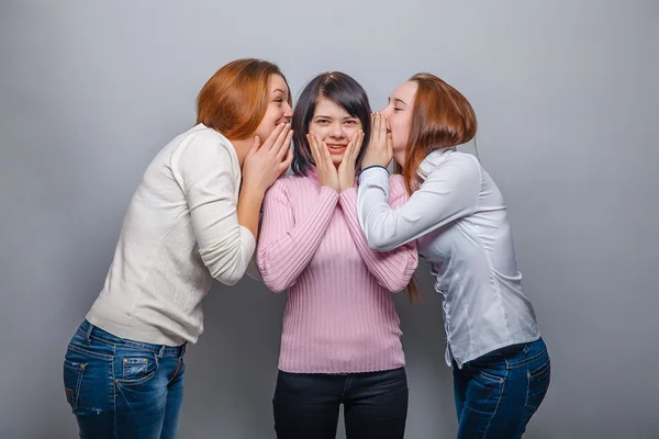 Три жінки жінка друзі дівчина плітки чутки сюрприз на сірому фоні — стокове фото