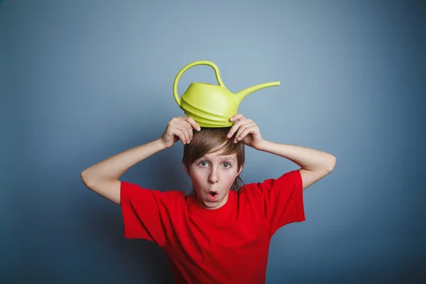 Boy teenager European appearance in a red shirt brown hair water — Stock Photo, Image