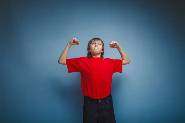 Boy in red t-shirt teenager brown hair European appearance shows — Stock Photo, Image