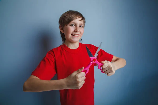 Boy teenager European appearance in a red shirt holding a brown — Stock Photo, Image