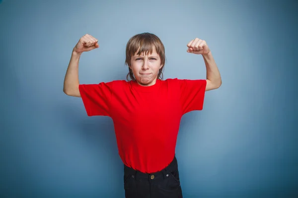 Boy in red t-shirt teenager brown hair European appearance shows — Stock Photo, Image