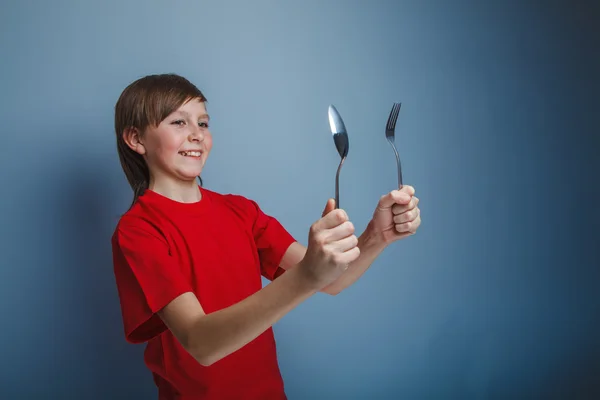 Boy teenager European appearance in a red shirt holding a Dark B — Stock Photo, Image