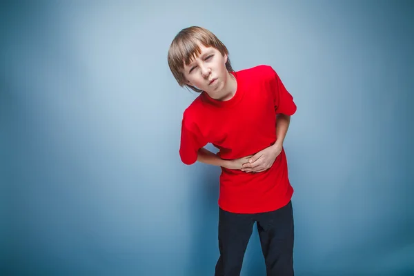 Teenager boy brown European appearance in a red shirt holding hi — Stock Photo, Image