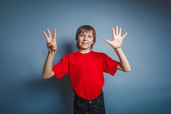 Teenager boy brown European appearance in a red shirt showing th — Stock Photo, Image