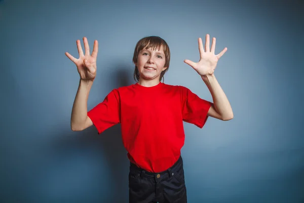 Teenager boy brown European appearance in a red shirt showing th — Stock Photo, Image