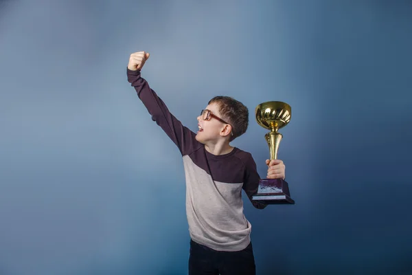 European-looking boy of ten years  in glasses  holding  a cup  i — Stock Photo, Image