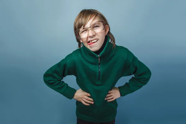 European-looking boy of ten years in glasses poses face shows to — Stock Photo, Image