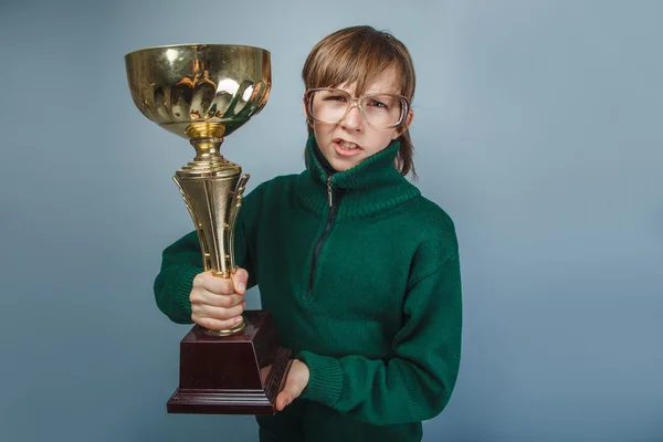 European-looking boy of ten years in glasses  holding a cup in — Stock Photo, Image