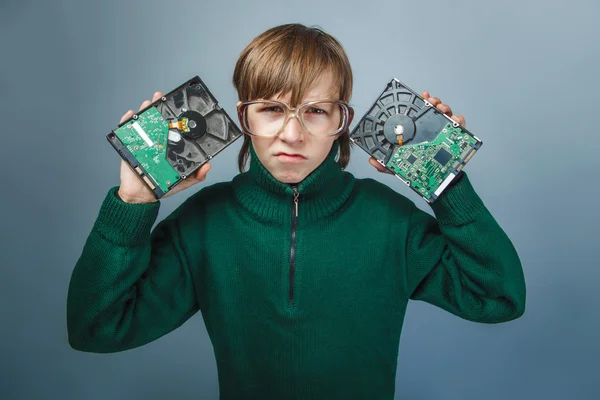 European-looking boy of ten years in glasses  holding a hard dri — Stock Photo, Image