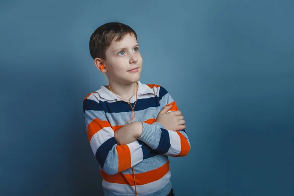 Europeiska-ser pojke på tio år med hörlurar lyssna t — Stockfoto