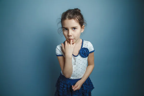 A girl of seven European appearance brunette stuck a finger in h — Stock Photo, Image