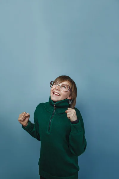 European-looking boy of ten years in glasses on gray  background — Stock Photo, Image