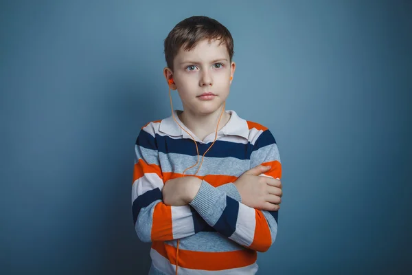 Teenager boy of about ten European appearance brown hair listeni — Stock Photo, Image