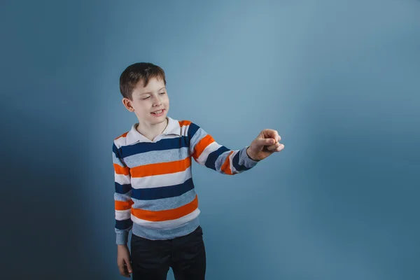 Boy teenager European appearance ten years writing in the air on — Stock Photo, Image