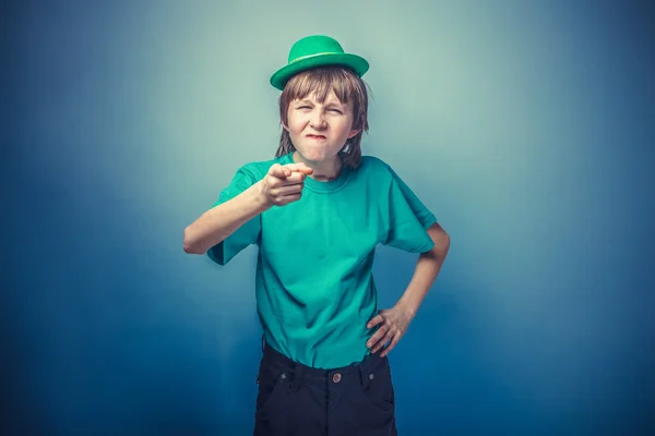 European-looking boy of ten years shows a finger at the camera, — Stock Photo, Image