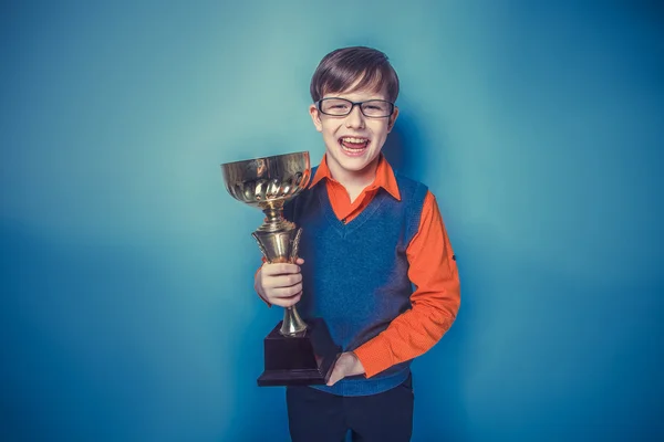 European-looking  boy of  ten years  in glasses holding a cup, a — Stock Photo, Image