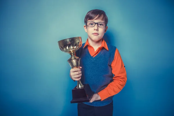 European-looking  boy of  ten years in glasses holding a cup, aw — Stock Photo, Image