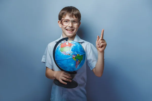 Un chico de 10 años de apariencia europea con gafas sosteniendo un —  Fotos de Stock